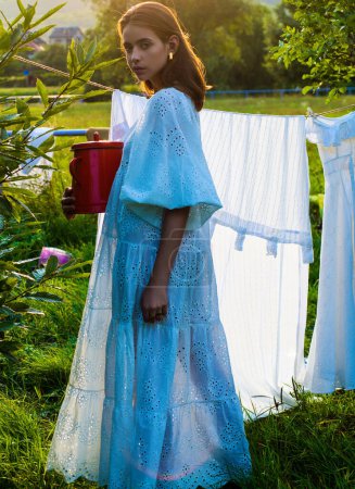 Téléchargez les photos : Country style woman in nature at the village outdoors. Beautiful sensual girl on summer day at countryside. Rustic style. Nature woman outdoor. Country girl. Nature woman outdoor - en image libre de droit