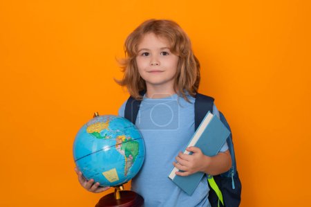 Photo for Pupil, nerd schoolboy. School boy world globe and book. School kid 7-8 years old with book go back to school. Little student. Education concept - Royalty Free Image