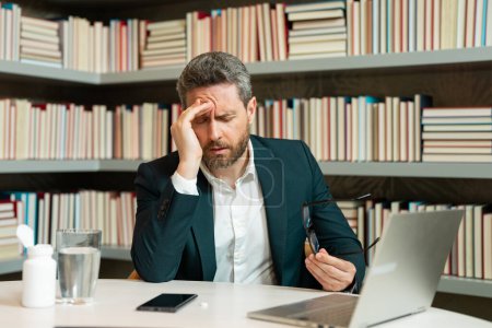 Photo for Business man feel pain holding glasses rubbing dry irritated eyes fatigued from computer work, stressed man suffer from headache bad vision sight problem sit at office. Deadline and stressed job - Royalty Free Image