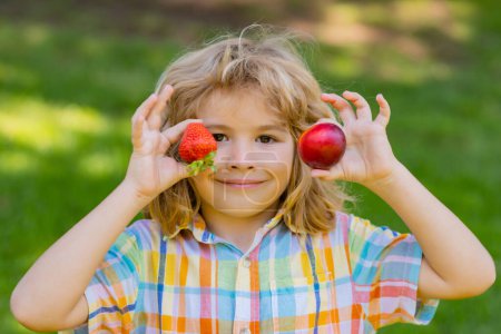 Photo for Summer kid face. Kid picking and eating ripe strawberry. Happy child holding fresh fruits berry strawberry. Healthy organic berry strawberries fruit, summer season - Royalty Free Image