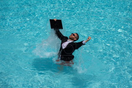 Photo for Freelance work, distance online work, e-working. Summer business. Business man in suit excited jumping with laptop in pool. Business man work online. Humor business concept - Royalty Free Image