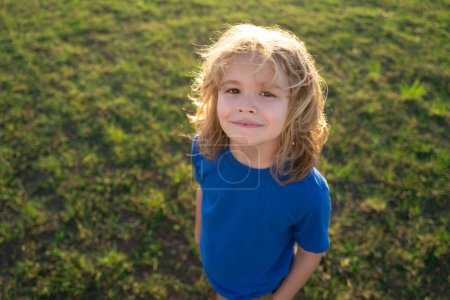 Photo for Child imagining idea concept. Lifestyle portrait of funny kid outdoors. Summer kids outdoor portrait. Close up face of cute child. Kid having fun outdoor on sunny summer day - Royalty Free Image