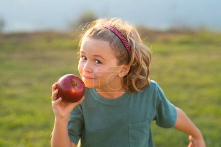 Photo for Fresh apple for kids. Child holding apple, summer park background. Kid eat green apple. Portrait of little happy smiling kid with apples. Healthy food - Royalty Free Image