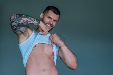 Photo for Seductive gay. Muscular body of man. Strong brutal guy. Sexy male naked torso. Nude muscular body man with tattoo showing fit muscular strong body. Muscular gay - Royalty Free Image