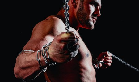 Man with chain. Young sports guy with a naked torso