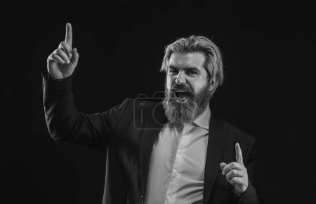 Photo for Happy attrative businessman in suit dancing and listening music and over black background - Royalty Free Image