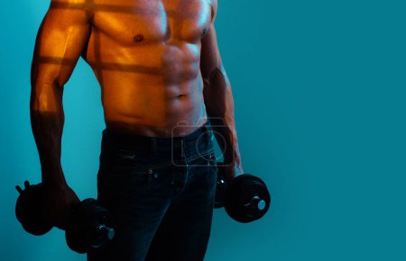 Photo for Shirtless bodybuilder is doing exercise with dumbbell - Royalty Free Image