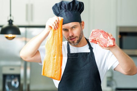 Photo for Portrait of chef man hold fish and meat, salmon and beef in a chef cap in the kitchen. Man wearing apron and chefs uniform and chefs hat. Raw meat beef and fish salmon fillet for advertising - Royalty Free Image