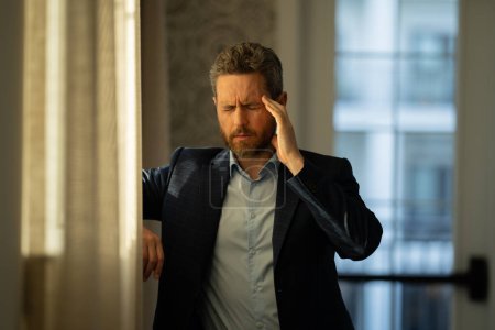 Photo for Tired man feel pain head. Close up portrait of stressed man suffer from headache at office. Stressed job. Painful man got migraine touches her head because of pain. Stressed, tired man from headache - Royalty Free Image