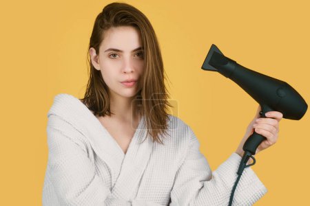 Photo for Woman using hair dryer. Young girl with drying hair with hair dry. Women hair care - Royalty Free Image