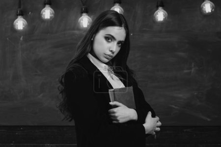 Photo for Portrait of girl teenager in school. Young teenager with school books. Back to school. Beautiful female holding her books in auditorium. Back to school and happy time - Royalty Free Image