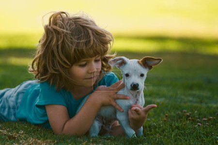 Photo for Boy child walk with puppy. Portrait kid boy with little dog - Royalty Free Image