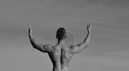 Photo for Power of freedom. Man muscular back blue sky background. Athletic bodybuilder muscular divine man. Dieting and fitness. Sport and workout. Sportsman showing biceps and triceps. Achieve great shape. - Royalty Free Image