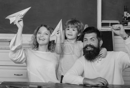 Photo for Family school. Pupil with paper airplane playing with parents. First day at school. Mathematics for kids. Family educational rights and privacy act - Royalty Free Image
