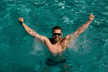 Photo for Pool resort. Happy man in swimming pool. Summer vacation. Man in sunglasses relaxing in swimming pool - Royalty Free Image