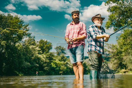 Photo for Men hobby and recreation. Fishermen successful catch fish. Fisher retirement. Retired businessman in suit with fishing rod. Male friendship. Granddad and drandson fishing - Royalty Free Image