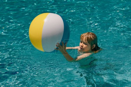 Photo for Kid boy in swimming pool on inflatable ring. Children swim with orange float. Water toy, healthy outdoor sport activity for children. Kids beach fun. Child splashing in summer water pool - Royalty Free Image