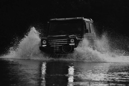 Photo for Mud and water splash in off-road racing. Expedition offroader. Drag racing car burns rubber. Extreme. Off-road car - Royalty Free Image