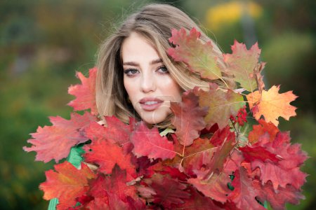 Photo for Young woman in autumn park. Warm sunny weather. Fall concept. Hello autumn. Happy woman with autumn yellow leaves outside. Beautiful autumn fall time in nature - Royalty Free Image