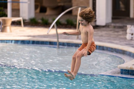 Photo for Kid jumping in swim pool. Kid playing in pool. Summer holidays and vacation concept. Happy child playing in the sea or swimming pool water. Summer vacation and healthy lifestyle concept - Royalty Free Image