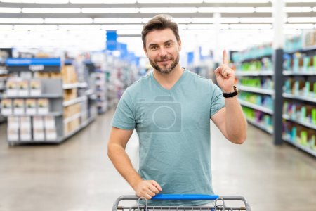 Photo for Shopping, discount, sale concept. Man with shopping trolley. Man at store. Supermarket and grocery shop concept. Man customers buying products at supermarket - Royalty Free Image