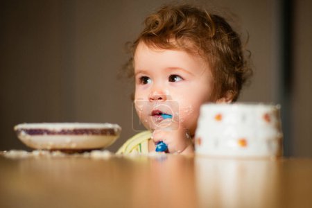 Photo for Child eating, nutrition concept. A baby eating food from a bowl - Royalty Free Image