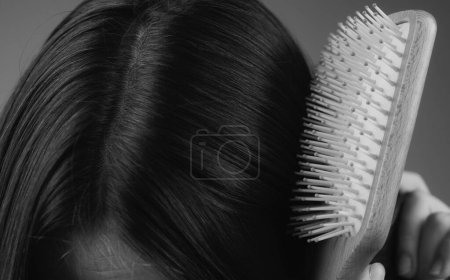 Photo for Closeup hair loss, hair fall in hairbrush, stress problem of woman with a comb - Royalty Free Image