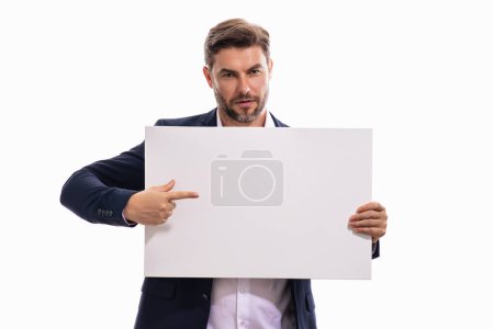 Photo for Man in studio showing promo blank board pointing finger on sign board. Blank signboard with copyspace. Advertisement concept. Ad board with copy space, blank mockup. Blank signboard, placard - Royalty Free Image