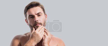 Photo for Closeup portrait of attractive man with cream on face. Beautiful man close up portrait on white background. Naked shoulders, skin care, health, cosmetics for skin. Banner for header, copy space - Royalty Free Image
