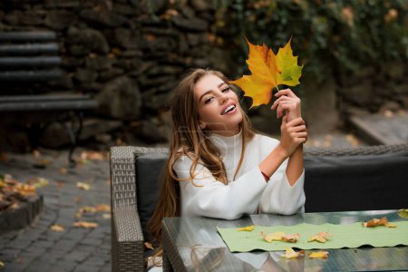 Photo for Beauty woman enjoy autumn. Leafs falling and people concept - Royalty Free Image