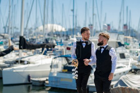 Photo for Portrait of sensual gay couple in love on wedding day near yacht boat. Romantic men same sex marriage. Gay couple wedding. Homosexual gay couple, LBGT couple at wedding ceremony, LGBTQ - Royalty Free Image