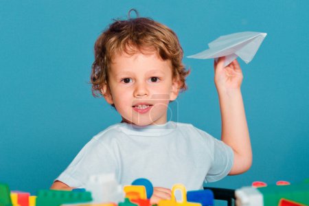 Photo for Little ready to study. Kid school. Little boy pupil with happy face expression hold paper plane laughing and smiling - Royalty Free Image