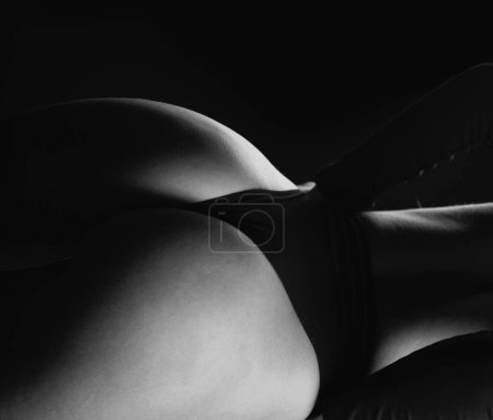 Foto de Female back and buttocks close up. Female butt in sexy bikini. Erotic lingerie. Bondage and bdsm concept. Seductive temptress. Slim woman dressed in lace lingerie. Lingerie sexy girl model on studio - Imagen libre de derechos