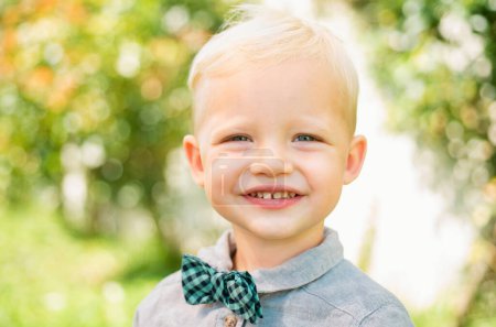 Photo for Spring kids smiling portrait. Closeup face of cute smiling spring child. Kid emotions concept. Portrait of young laughing boy outdoor. Blonde child. Happy kids emotions, smiling face - Royalty Free Image
