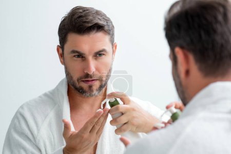 Photo for Handsome aged man applying face cream. Beauty routine. Man with perfect skin. Anti-aging and wrinkle cream. Concept of male beauty. Close up face of man applying cream to skin. Skincare and cosmetics - Royalty Free Image