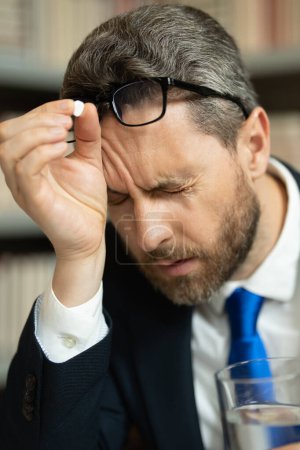 Photo for Close up portrait of stressed man with headache migraine. Business man suffering from headache after computer work, exhausted with closed eyes touching head, relieving pain, migraine - Royalty Free Image