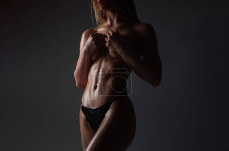 Photo for Sexy breast and slim belly. Topless sexy womans body with nude sexy belly. Sensual beauty female belly, slim nude young model undressed in studio. Naked strip female body. Sexy girl - Royalty Free Image
