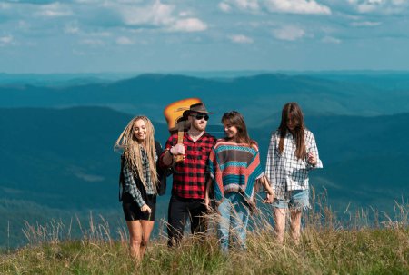 Photo for Countryside hiking. Hiking youth group. Adventure travel hike and tourist people. Healthy lifestyle and eco tourism - Royalty Free Image