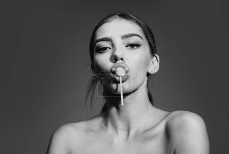 Photo for Sexy woman face. Close-up portrait of nice alluring charming glamorous sweet sexy lady with lollipop in mouth. Sucking licking red sweet candy - Royalty Free Image