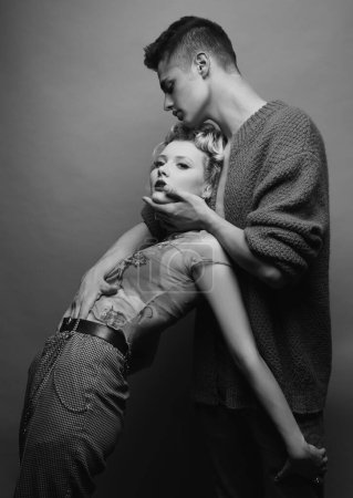 Photo for Portrait of lovely couple in love. Young sensual girlfriend glad to passionate kiss from her boyfriend. Handsome young man embraces his woman and kisses - Royalty Free Image