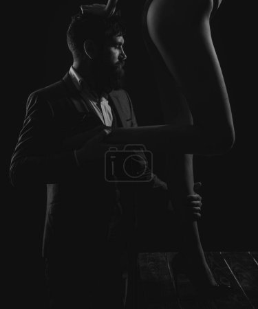 Foto de Fetish legs. Fashion portrait of attractive young man with womans sexy legs - Imagen libre de derechos