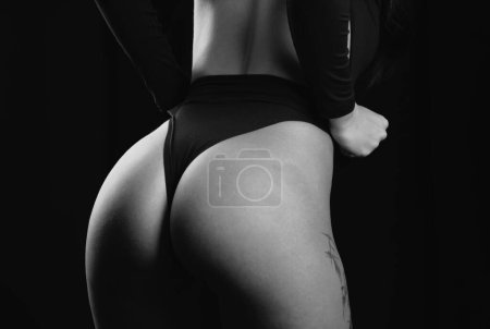 Foto de Sexy female butt in black panties. Models in underwear sexy bikini. Woman butt in underwear in studio. Sexy lingerie, beautiful underclothes - Imagen libre de derechos