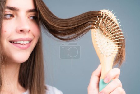 Photo for Close up portrait of happy beautiful girl with shiny hair with comb - Royalty Free Image