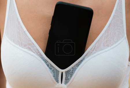 Foto de Sensual boob. Woman with breasts and mobile phone. Woman with great boobs. Women sexy shape tits. Breast sexy - Imagen libre de derechos