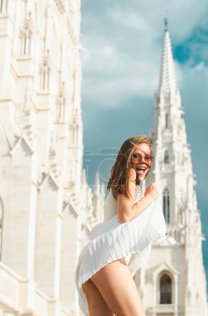 Photo for Beautiful young crazy woman in the city street. Beautiful young fashion woman. Movement sexy excited smiling woman - Royalty Free Image