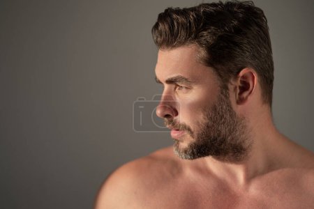 Sexy shirtless man close up portrait care of skin, isolated over white background. Charming man with perfect smooth soft skin. Spa therapy. Man, face, beauty and skincare concept