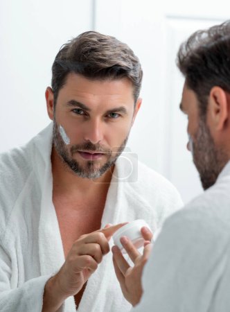 Photo for Male cosmetic. Beauty man applying face cream. Skin care cosmetic. Male cosmetics face cream. Facial cream, moisturizing lifting creme. Face cream for skincare. Wrinkle cosmetic facial treatment - Royalty Free Image