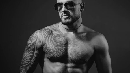 Photo for Confident and handsome Brutal man. Man glasses. Stylish sexy man looking away. Handsome brutal man on gray background. Portrait of the brutal handsome male model. Sexy model in aviator sunglasses. - Royalty Free Image
