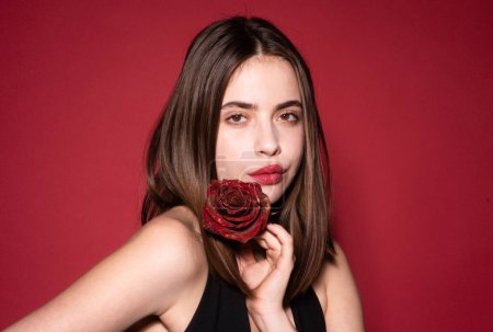 Photo for Close-up portrait of young beautiful sexy woman with red rose near face. Vogue spring summer style. Perfume cosmetics concept. Nofilter unaltered skin. Natural skin texture - Royalty Free Image