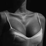 Closeup sexy woman boobs and slim body, female sexy breast. Isolated on black, close up
